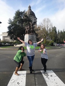 Three teens posing at the Capitol Building in Olympia, WA