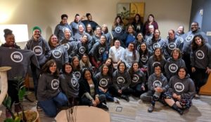 Attendees from WSCADV and WCSAP's 2019 Prevention Retreat sitting in a group smiling.