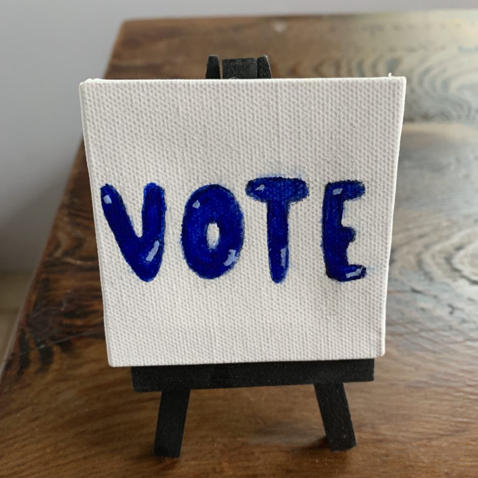 miniature canvas with the word "VOTE' painted on it