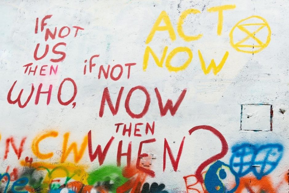 Spray painted wall that says "If not us, then who? If not now, then when?"