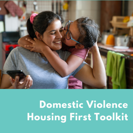 A Latina mom and daughter smaling together. The daughter has her arms around her mom and the mom is holding a phone. Text says "Domestic Violence Housing First Toolkit"