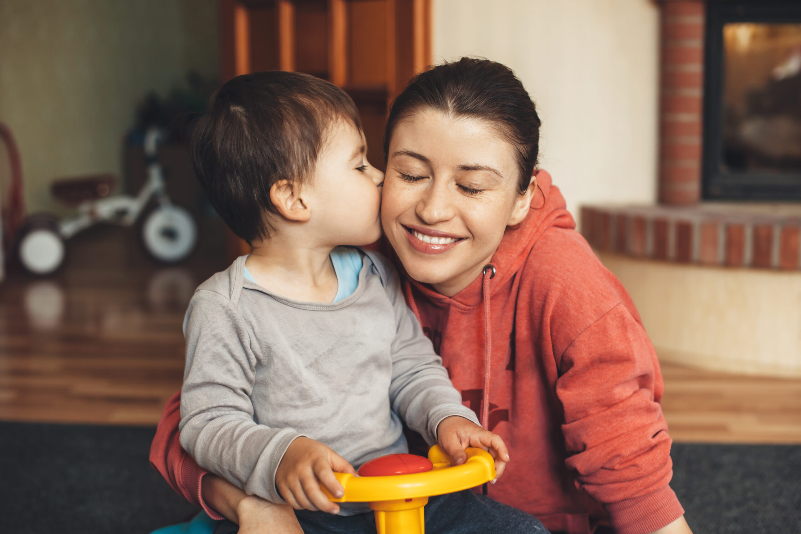 Small boy and mother smiling with their heads close together